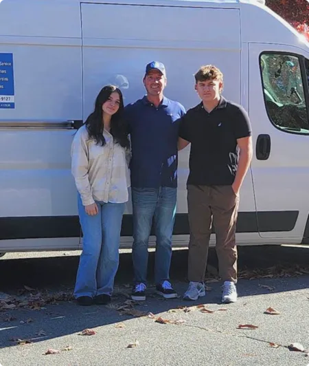 James Mathus of Optimum Plumbing & Heating with his family in front of the company van