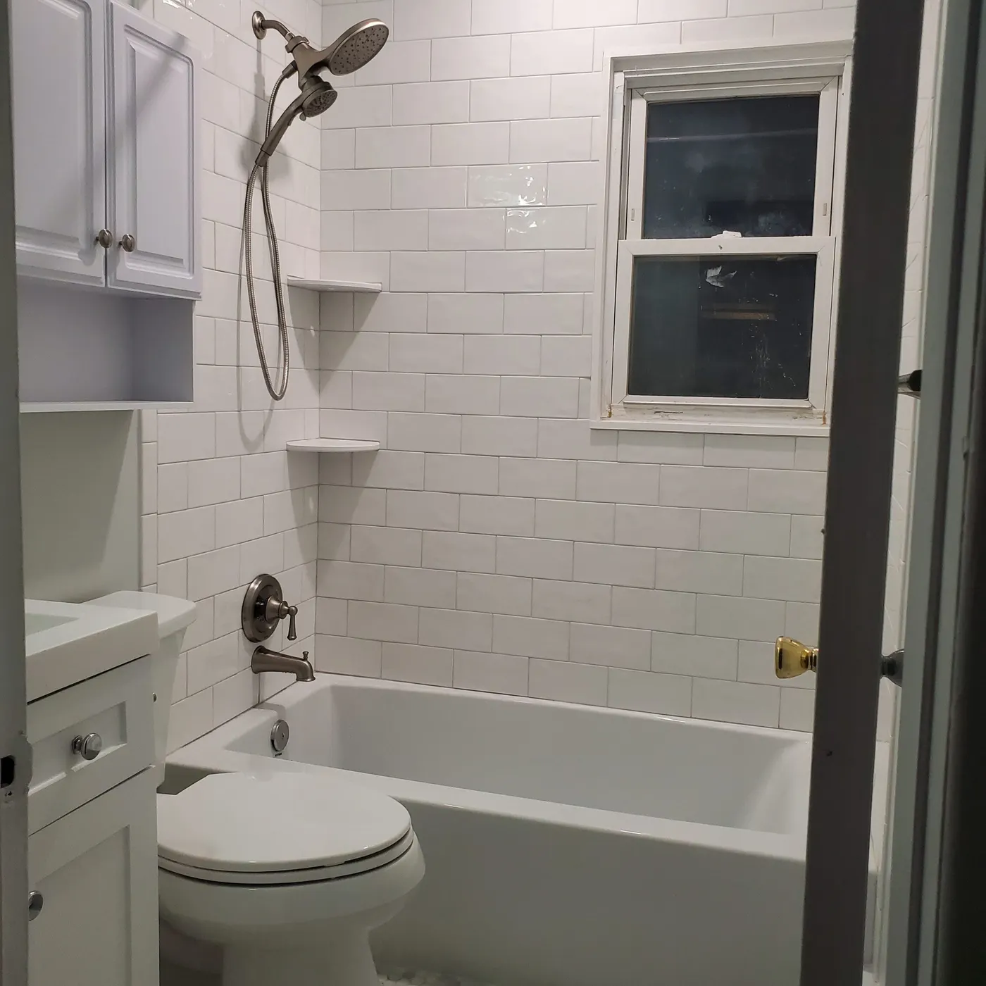Finished tub and shower with white subway tile