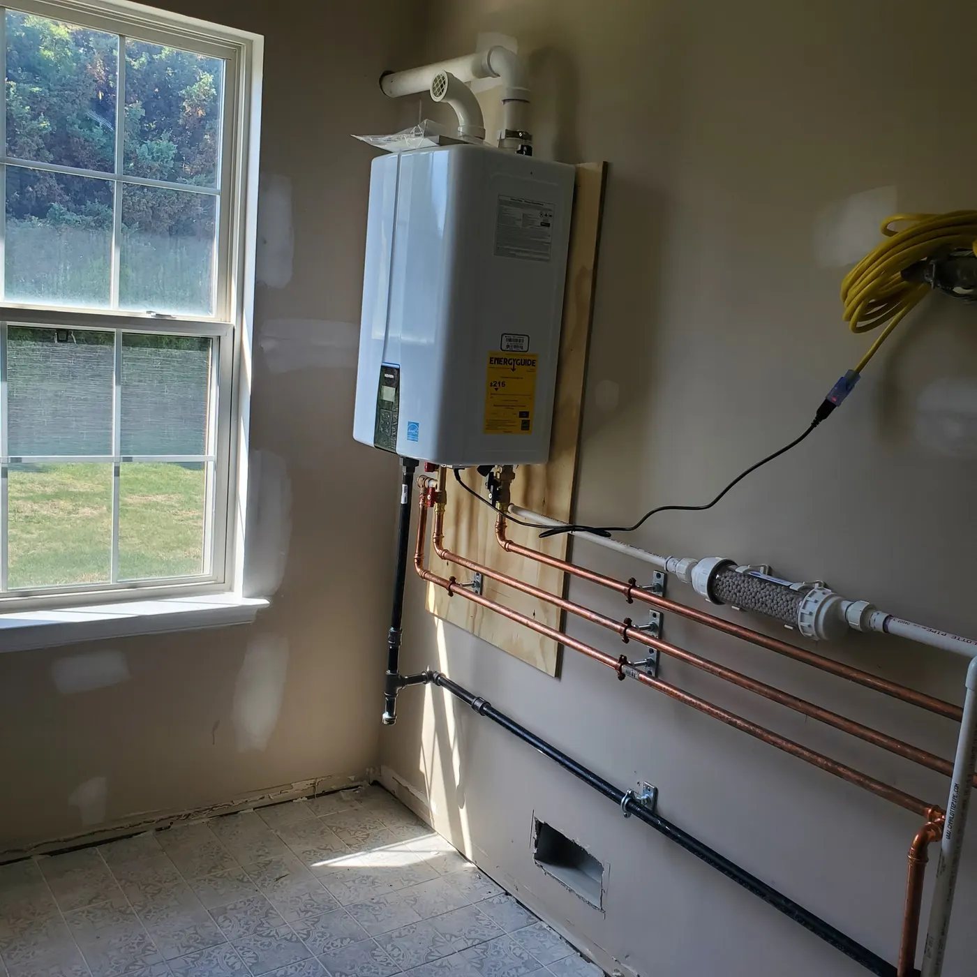 Tankless water heater installed with clean copper piping